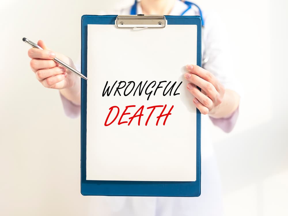 Doctor holding paper board with 'Wrongful Death' inscription