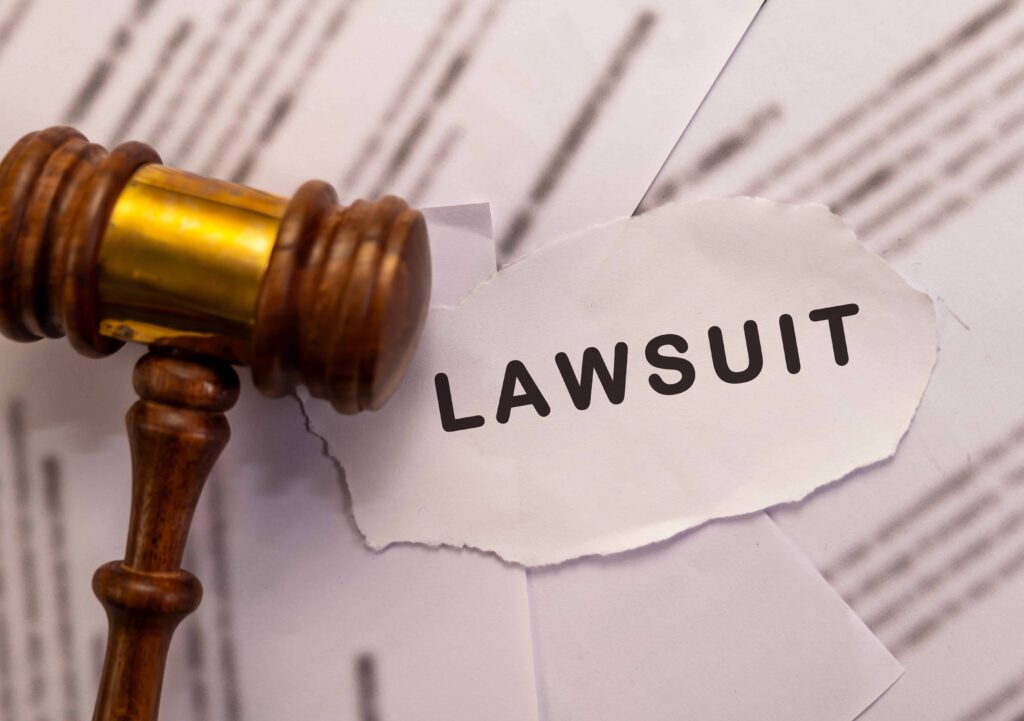 Judge&rsquo;s gavel resting on legal documents with the word &lsquo;lawsuit&rsquo; displayed